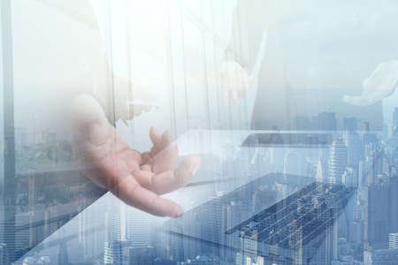 Double exposure partner business team making great business discussion in conference room at coworking office with skyscraper building blurred background,teamwork process and analyze business startup investment plans  concept,の写真素材