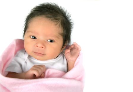 An alert smilingnewborn baby girl on a white background ith copy space の写真素材
