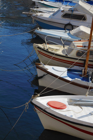 A few boats at moorage by a large plan