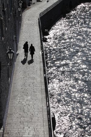 Two womanish silhouette on to the embankmentの写真素材