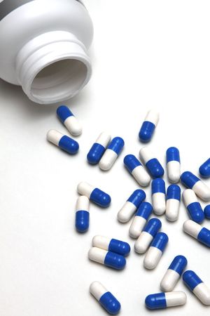 Scattered tablets or vitamins on a light backgroundの写真素材