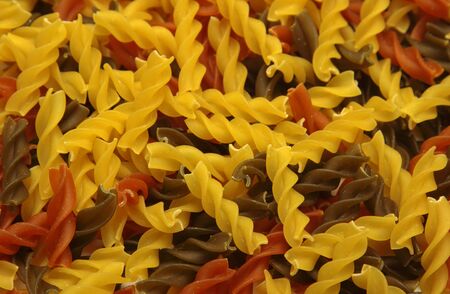 Coloured macaronis by a large planの写真素材