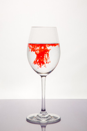red liquid in wine glassの写真素材