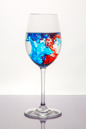 red and blue liquid in wine glassの写真素材
