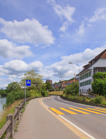 Road in Switzerland with Zug city buildings at the and lake Zug on the left sideの写真素材