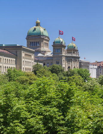 Federal Palace of Switzerland building decorated with Flags of Switzerland.
