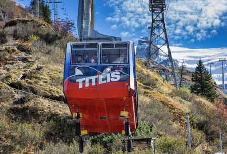 Mt. Titlis, Switzerland - 12 October, 2015: cable car gondola with passengers heading upwards. Titlis also Mount Titlis is a mountain of the Uri Alps, located on the border between the cantons of Obwalden and Bern. At 3,238 metres above sea level, it is tのeditorial素材
