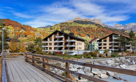 Engelberg, Switzerland - 12 October, 2015: wooden pedestrian bridge over the Engelberger Aa river. Engelberger Aa or Engelbergeraa is a river, which rises west of Surenenpass in the Canton of Uri, flows through the valley of Engelberg Canton of Obwalden.のeditorial素材