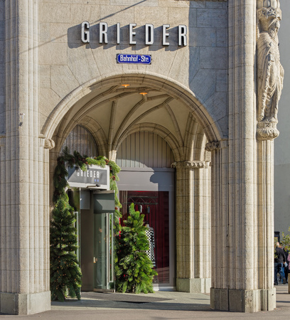 Zurich, Switzerland - 2 December, 2015: entrance of the Bongenie Grieder store on the Bahnhofstrasse street decorated with Christmas trees. Bongenie Grieder group owns 25 stores throughout Switzerland, offering designer clothes, fashion accessories, etc.のeditorial素材