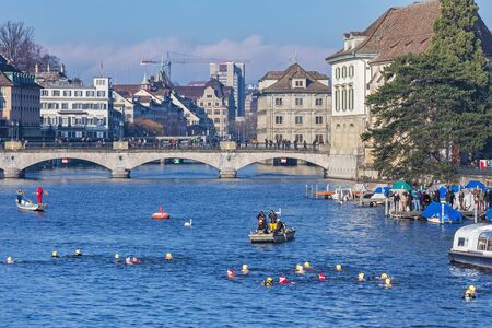 Zurich, Switzerland - 6 December, 2015: participants of the Zurich Samichlaus-Schwimmen crossing the Limmat river. Zurich Samichlaus-Schwimmen began in the year 2000 with 65 participants and has developed into the second largest winter swimming event in Sのeditorial素材