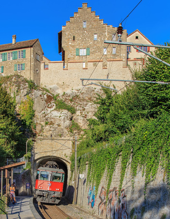 Laufen, Switzerland - 26 August, 2015: train arriving through the tunnel under the Laufen Castle to the Laufen Castle railway station. Laufen Castle German: Schloss Laufen is a castle in the municipality of Laufen-Uhwiesen in the Canton of Zurich. It is aのeditorial素材