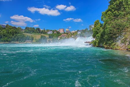 Laufen, Switzerland - 16 July, 2014 - view on the town of Neuhausen am Rheinfall and the Rhine Falls over the Rhine river. The Rhine Falls Rheinfall in German is the largest plain waterfall in Europe, located on the Rhine river between the municipalities のeditorial素材