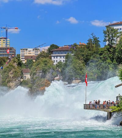 Laufen, Switzerland - 16 July, 2014 - view on the town of Neuhausen am Rheinfall and the Rhine Falls over the Rhine river. The Rhine Falls Rheinfall in German is the largest plain waterfall in Europe, located on the Rhine river between the municipalities のeditorial素材