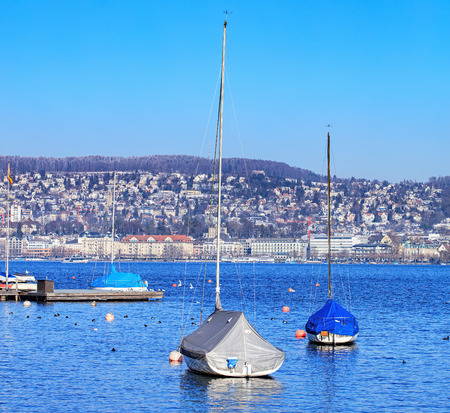 Zurich, Switzerland - 21 January, 2016: yachts on Lake Zurich on a somewhat foggy day in winter. Lake Zurich is a lake in Switzerland, extending southeast of the city of Zurich. It is formed by the Linth river, which rises in the glaciers of the Glarus Alのeditorial素材