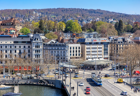 Zurich, Switzerland - 11 April, 2016: pedestrians and traffic on Quaibruecke bridge and Bellevue square, view from the Ferris wheel temporarily installed on Burkliplatz square. Zurich is the largest city in Switzerland and the capital of the Swiss canton のeditorial素材