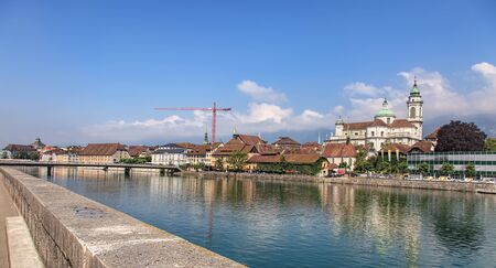 Solothurn, Switzerland - 19 July, 2013: view with Aare river and the St. Ursus cathedral. Aare is the longest river that both rises and ends entirely within Switzerland. The St. Ursus Cathedral is a Swiss heritage site of national significance.のeditorial素材