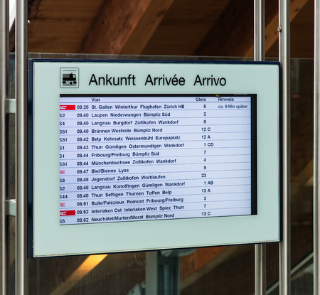 Bern, Switzerland - 19 October, 2015: arrival board mounted on a transparent wall at one of the entrances of the Bern train station. The city of Bern is the capital of Switzerland and also the capital of the Swiss canton of Bern.のeditorial素材