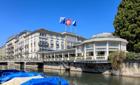 Zurich, Switzerland - 20 April, 2016: the Baur au Lac Hotel building decorated with flags of Zurich and Switzerland, view from Am Schanzengraben embankment. The Baur au Lac Hotel is a luxury hotel in Zurich, Switzerland, founded in 1844 by Johannes Baur.のeditorial素材