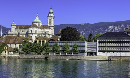 Solothurn, Switzerland - 10 July, 2016: buildings on the Ritterquai quay of the Aare river with towers of the St. Ursus Cathedral in the background. The city of Solothurn is the capital of the Swiss Canton of Solothurn and is also the only municipality ofのeditorial素材