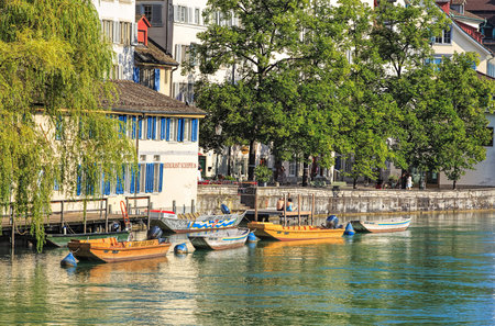 Zurich, Switzerland - 30 July, 2016: boats on the Limmat river in the historic Schipfe quarter. Zurich is the largest city in Switzerland and the capital of the Swiss canton of Zurich.のeditorial素材
