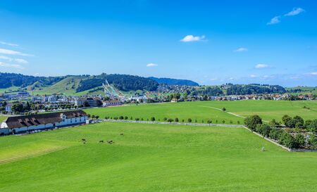 Einsiedeln, Switzerland - 8 September, 2015: view on the town with the ski jumping venue in the background. The ski jumping venue in Eschbach, Einsiedeln was built in 2001. In 2010 the venue became the National Ski jumping venue of Switzerland.のeditorial素材