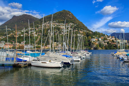 Lugano, Switzerland - 12 October, 2016: view on Lake Lugano, Monte Bre and Monte Boglia mountains in the background. Lake Lugano is a glacial lake on the border between southern Switzerland and northern Italy.のeditorial素材