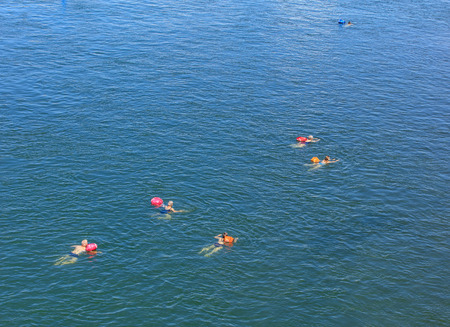 Basel, Switzerland - 27 August, 2016: people swimming in the Rhine river, view from the Johanniterbruecke bridge. Basel is a city on the Rhine river in northwestern Switzerland, situated where the Swiss, German and French borders meet.のeditorial素材