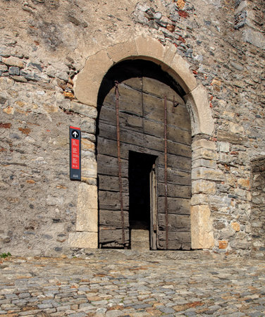 Wooden gate inside medieval fortress Castelgrande in Bellinzona, Switzerland. The Castelgrande fortress belongs to the Swiss Inventory of Cultural Property of National and Regional Significance. The city of Bellinzona is the capital of the Swiss canton ofのeditorial素材