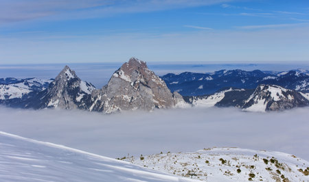 Summits of Kleiner Mythen and Grosser Mythen mountains rising from sea of fog, wintertime view from...