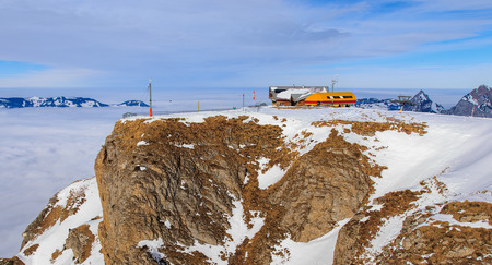 Mt. Fronalpstock, Switzerland - 24 January, 2017: the chair lift station and restaurant on the top of the mountain on a cloudy day in winter. The Fronalpstock is a mountain in the Swiss canton of Schwyz, it has an elevation of 1,921 meters above sea levelのeditorial素材