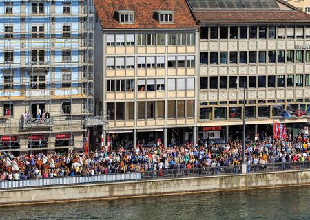 Zurich, Switzerland - 13 April, 2015: people on the embankment of the Limmat river during the Sechselauten celebration. The Sechselauten is a traditional spring holiday in the city of Zurich.のeditorial素材