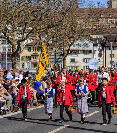 Zurich, Switzerland - 12 April, 2015: participants of children's parade devoted to the upcoming Sechselauten holiday passing along Uraniastrasse street. The Sechselauten is a traditional spring holiday in the city of Zurich, children's parade (German: Kinのeditorial素材