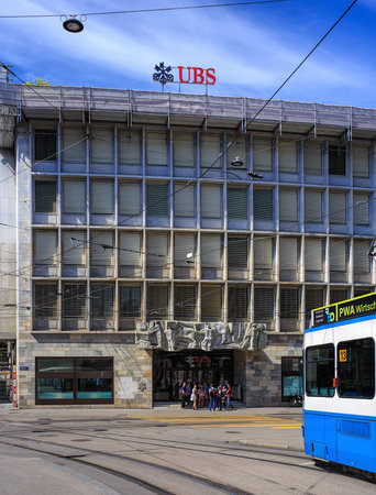 Zurich, Switzerland - 14 May, 2015: people at the entrance to the UBS office on Talacker street, a tram passing, view from Paradeplatz square. UBS AG is a Swiss global financial services company.のeditorial素材