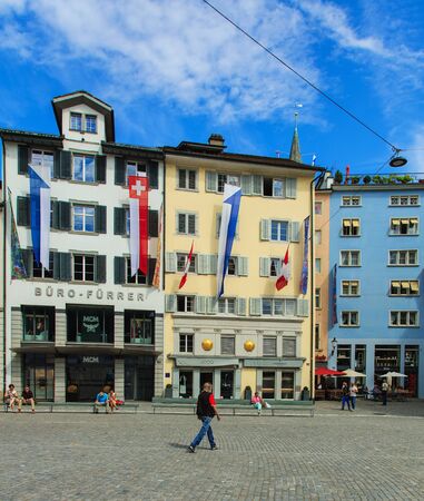 Zurich, Switzerland - 1 August, 2016: buildings on Munsterhof square decorated with flags of Switzerland and Zurich for the Swiss National Day, people on the square. The Swiss National Day is the national holiday of Switzerland, celebrated on 1 August.のeditorial素材