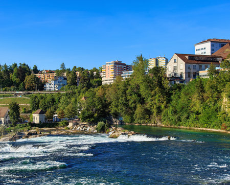 Neuhausen am Rheinfall, Switzerland - 26 August, 2015: the Rhine river just above the Rhine Falls. The Rhine is a European river that begins in the Swiss canton of Graubunden and empties into the North Sea in the Netherlands.のeditorial素材