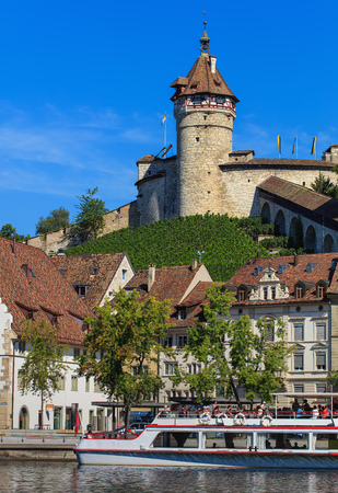 Schaffhausen, Switzerland - 29 August, 2015: buildings along the Rhine river, people on board of a boat, the Munot fortress. Schaffhausen is a city in northern Switzerland and the capital of the Swiss canton of Schaffhausen.のeditorial素材