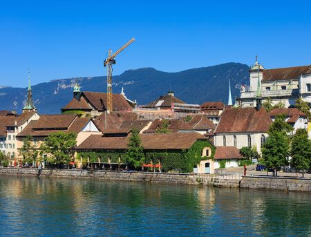 Solothurn, Switzerland - 10 July, 2016: buildings of the city of Solothurn along the Aare river, mountains in the background. The city of Solothurn is the capital of the Swiss canton of Solothurn.のeditorial素材