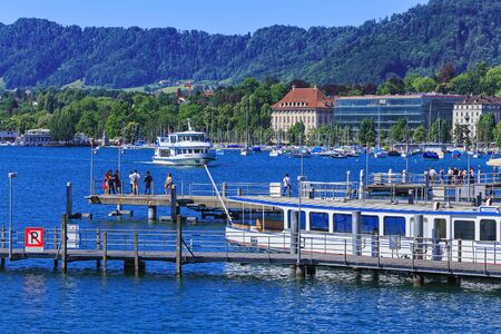 Zurich, Switzerland - 18 June, 2017: boats and piers on Lake Zurich, people on the piers. Lake Zurich is a lake in Switzerland, extending southeast of the city of Zurich, which is the largest city in Switzerland.のeditorial素材