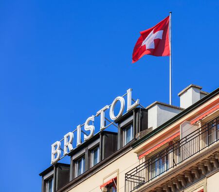 Geneva, Switzerland - 24 September, 2016: sign and flag of Switzerland on the roof of the Hotel Bristol Geneva in the city of Geneva. Hotel Bristol Geneva is a 4-star hotel, located only 1.8 km from United Nations Geneva and PalExpo, built in 1896 and refのeditorial素材