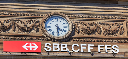 Zurich, Switzerland - 20 July, 2016: a clock and the sign of the Swiss Federal Railways on the facade of the Zurich Main railway station. Zurich Main railway station building was designed by architect Jakob Friedrich Wanner and opened in 1871.のeditorial素材