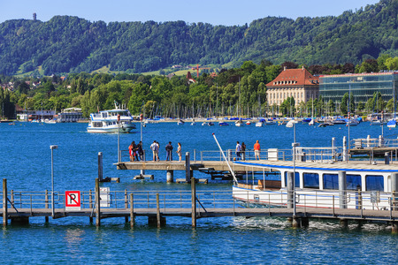 Zurich, Switzerland - 18 June, 2017: boats and piers on Lake Zurich, people on the piers. Lake Zurich is a lake in Switzerland, extending southeast of the city of Zurich, which is the largest city in Switzerland.のeditorial素材