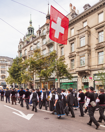 Zurich, Switzerland - 1 August, 2014: participants of the parade devoted to the Swiss National Day passing along Bahnhofstrasse street. The Swiss National Day is the national holiday of Switzerland, celebrated on the 1st August.のeditorial素材