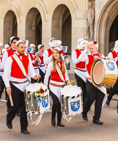 Zurich, Switzerland - 13 April, 2015: participants of the Sechselauten parade passing along a street...
