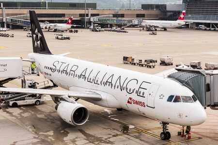 Kloten, Switzerland - 5 August, 2015: Airbus A320-214 of the Star Alliance at a terminal at Zurich Airport on an overcast day. Zurich Airport, also known as Kloten Airport, is the largest airport in Switzerland and the principal hub of the Swiss Internatiのeditorial素材