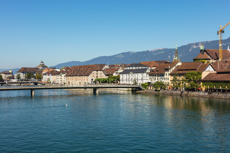 Solothurn, Switzerland - 10 July, 2016: buildings of the historic part of the city of Solothurn along the Aare river, summits of the Alps in the background. Solothurn is a city located in the north-west of Switzerland, it is the capital of the Swiss cantoのeditorial素材