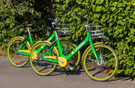 Zurich, Switzerland - May 11, 2018: two LimeBikes parked on the street. LimeBike operates a fleet of free-floating rental bikes throughout Zurich.のeditorial素材
