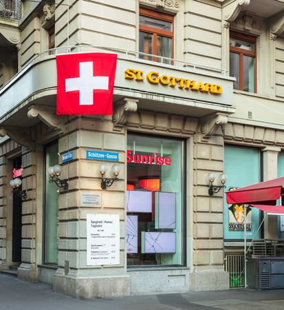 Zurich, Switzerland - August 1, 2018: facade of the Hotel St. Gotthard building decorated with a flag of Switzerland. Hotel St. Gotthard is located on Bahnhofstrasse street in Zurich's downtown, it was established by Kaspar Manz in 1889.のeditorial素材