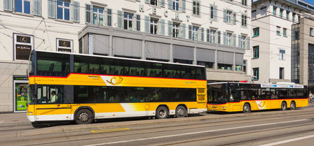 St. Gallen, Switzerland - September 19, 2018: two PostAuto buses at the Marktplatz stop in the city...