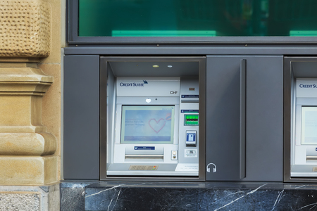 Zurich, Switzerland - August 1, 2016: an ATM of the Credit Suisse bank. The Credit Suisse Group AG is a Swiss multinational investment bank and financial services company headquartered in Zurich.のeditorial素材