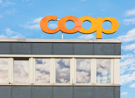 Zurich, Switzerland - October 25, 2017: upper part of a building holding a sign of the Coop Group. The Coop Group is one of Switzerland's largest retail and wholesale companies.のeditorial素材